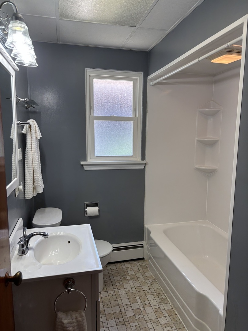 1378 East Street Crete, IL 60417 - Photo 10 of 12 a bathroom with a sink a bathtub and a mirror