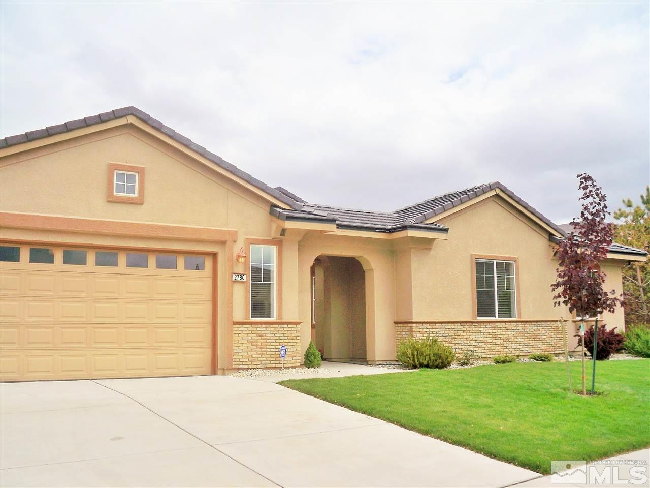 2780 Bull Rider Drive Reno, NV 89521 - Photo 1 of 1 a front view of a house with a yard and garage