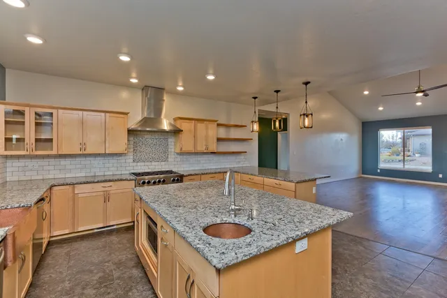 a kitchen with stainless steel appliances granite countertop a sink stove and cabinets