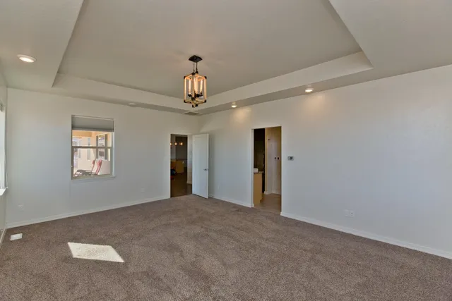 a bathroom with a granite countertop double vanity sink and a mirror