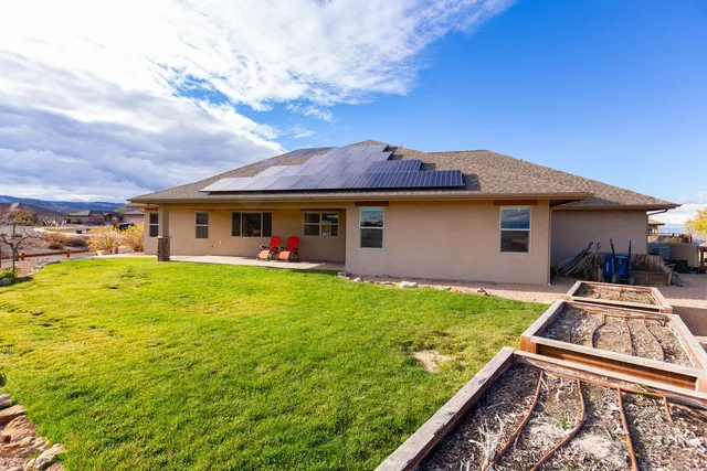 a view of a house with pool and a yard