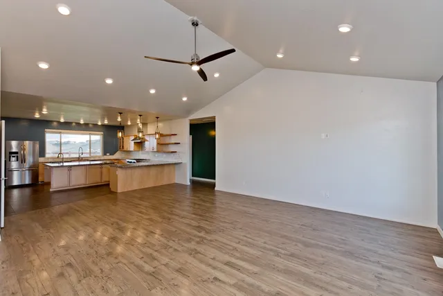 a view of kitchen with kitchen island a sink appliances and cabinets