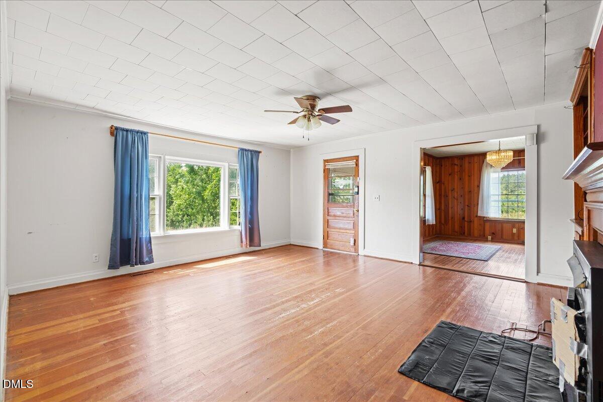 109 Little Ponderosa Road Macon, NC 27551 - Photo 16 of 32 wooden floor in an empty room with a window