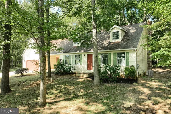 a front view of a house with a yard garage and outdoor seating