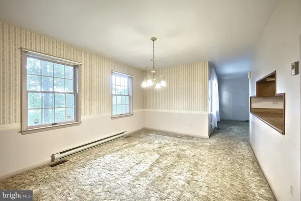 a kitchen with a sink dishwasher a stove top oven a kitchen island with wooden cabinets and floor