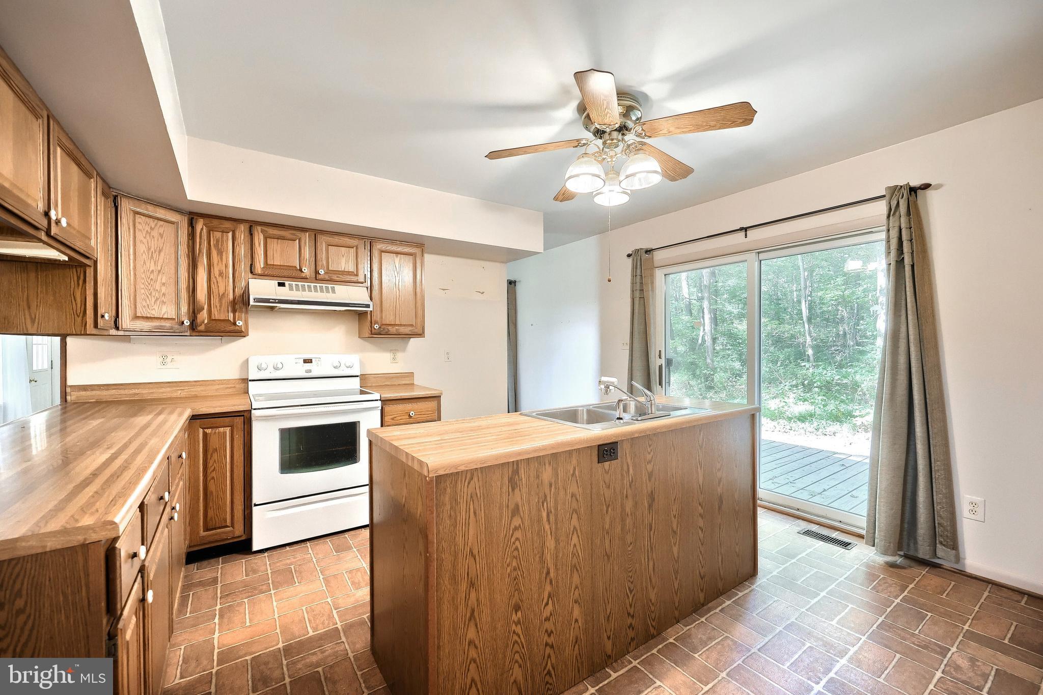 1059 Main St Extension Felton, PA 17322 - Photo 28 of 63 a kitchen with a stove a sink and a refrigerator