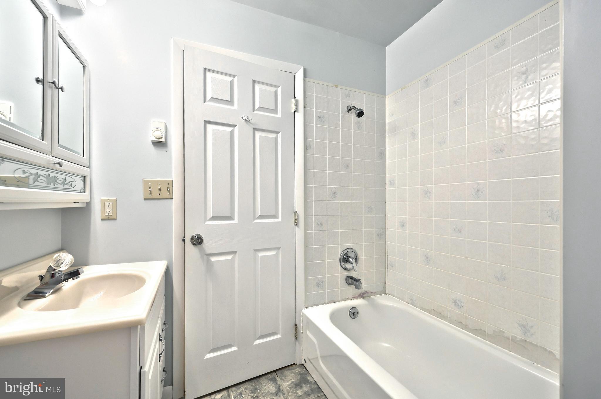 1059 Main St Extension Felton, PA 17322 - Photo 40 of 63 a bathroom with a tub sink shower and mirror
