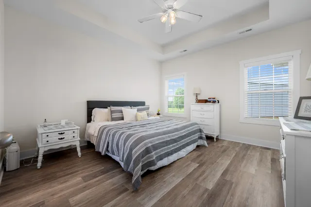 a bedroom with a bed and a chandelier