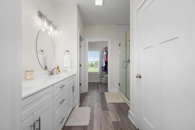 a bathroom with a double vanity sink and a mirror