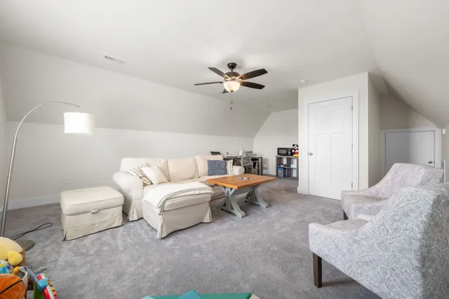 a view of a patio with chairs and table under an umbrella