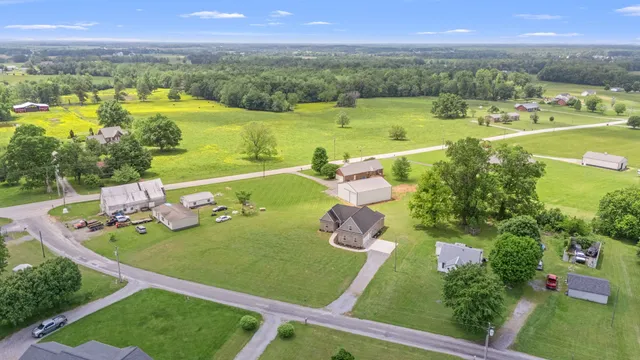 a view of a house with a yard and sitting area