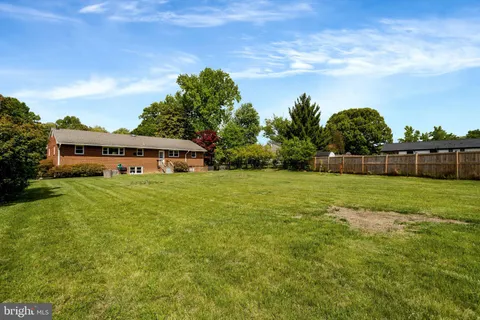 a front view of a house with a yard and potted plants