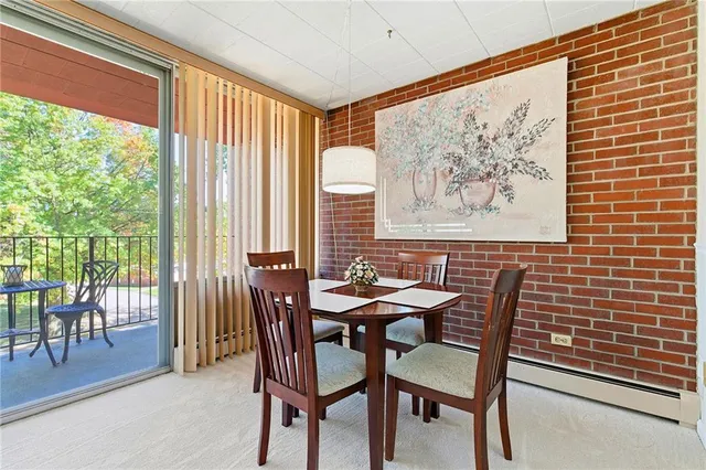 a view of a dining room with furniture and a large window
