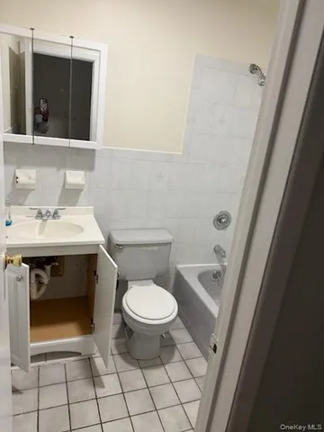 a bathroom with a sink toilet and mirror