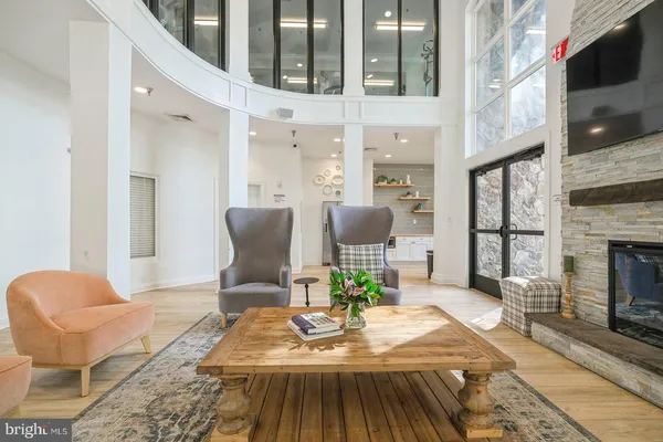 a living room with furniture a fireplace and a flat screen tv