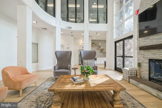 a living room with furniture a fireplace and a flat screen tv