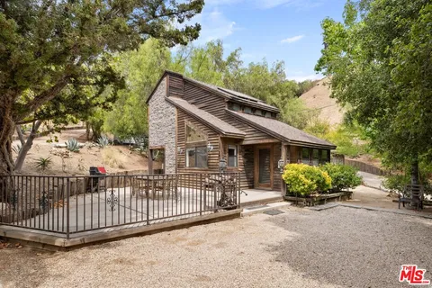 a view of a house with a balcony and garden