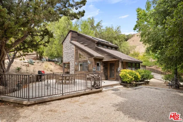 a view of a house with a balcony and garden