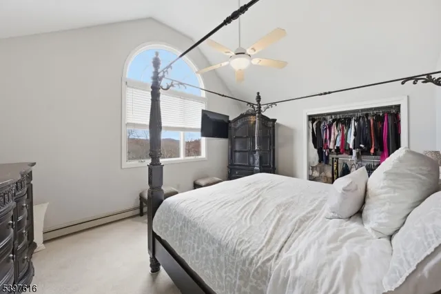 a bedroom with a bed and a mirror