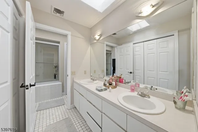 a bathroom with a double vanity sink mirror and double