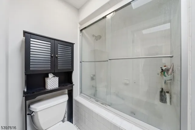 a bathroom with a shower and a toilet