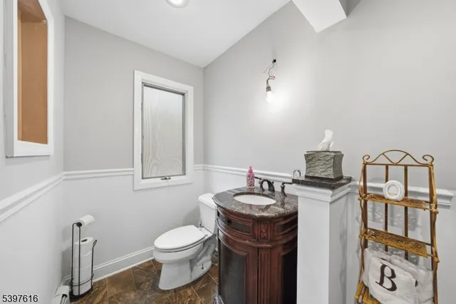 a bathroom with a toilet a sink and mirror
