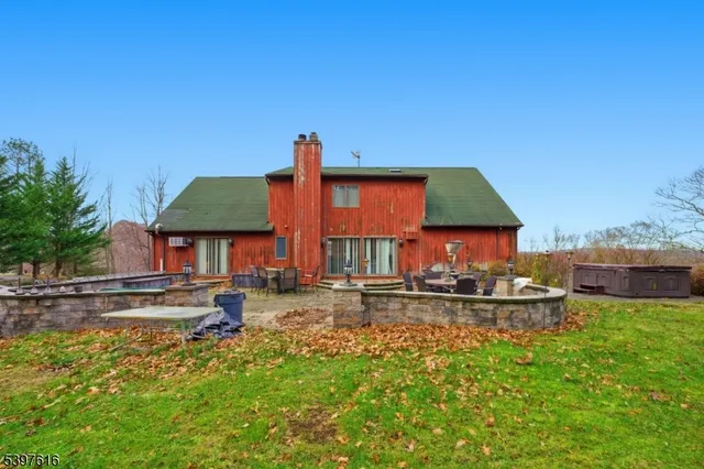 a backyard of a house with table and chairs