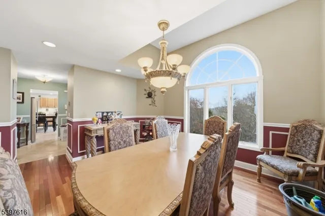 a view of a dining room with furniture wooden floor and chandelier