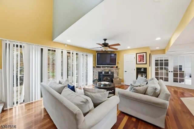 a living room with furniture a fireplace and a large window