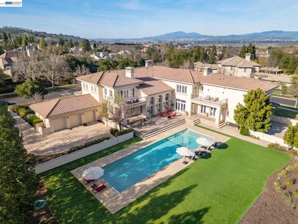 an aerial view of a house with a big yard