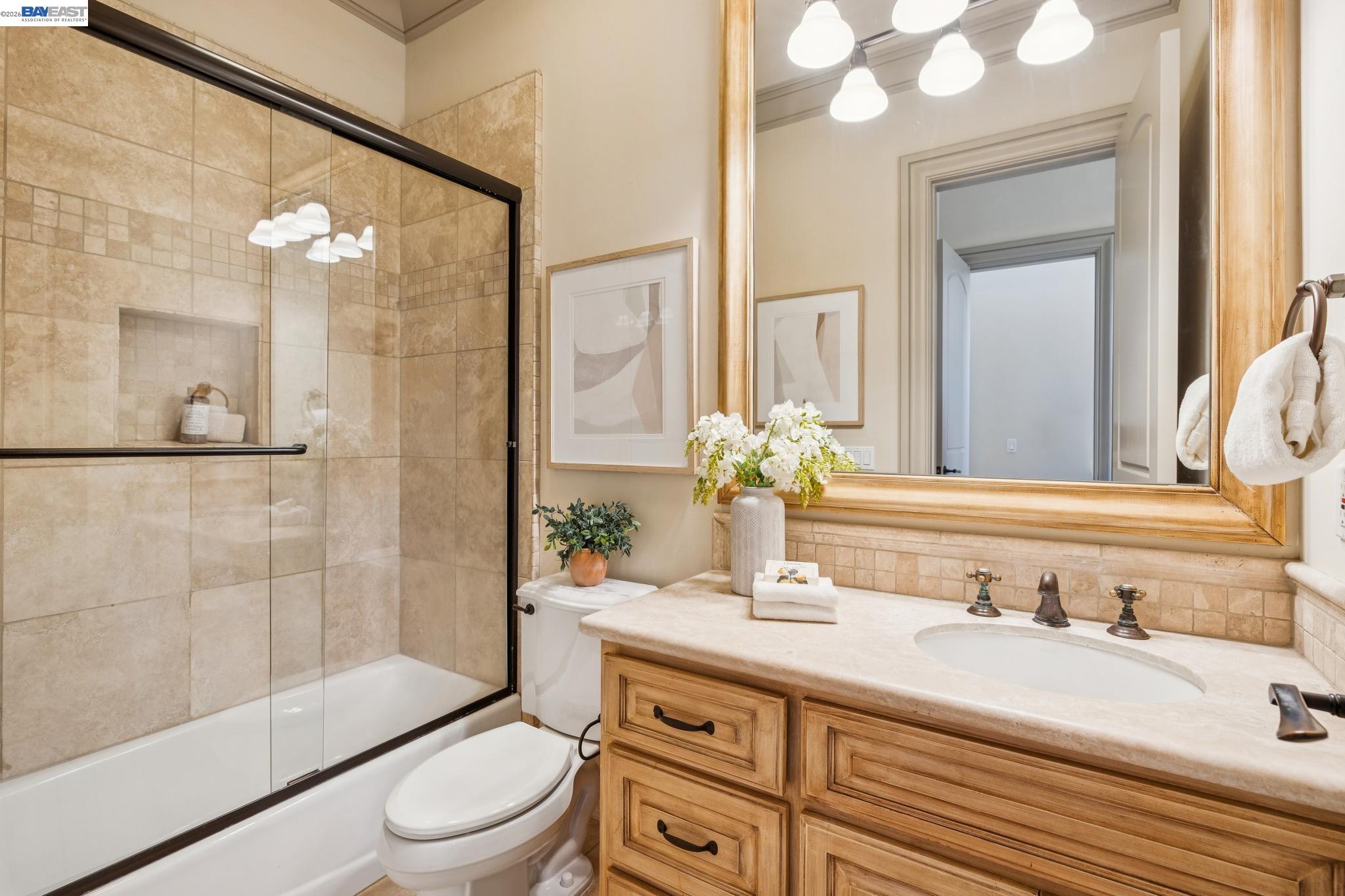 1398 Piemonte Drive Pleasanton, CA 94566 - Photo 33 of 60 a bathroom with a granite countertop sink toilet a mirror a vanity and shower