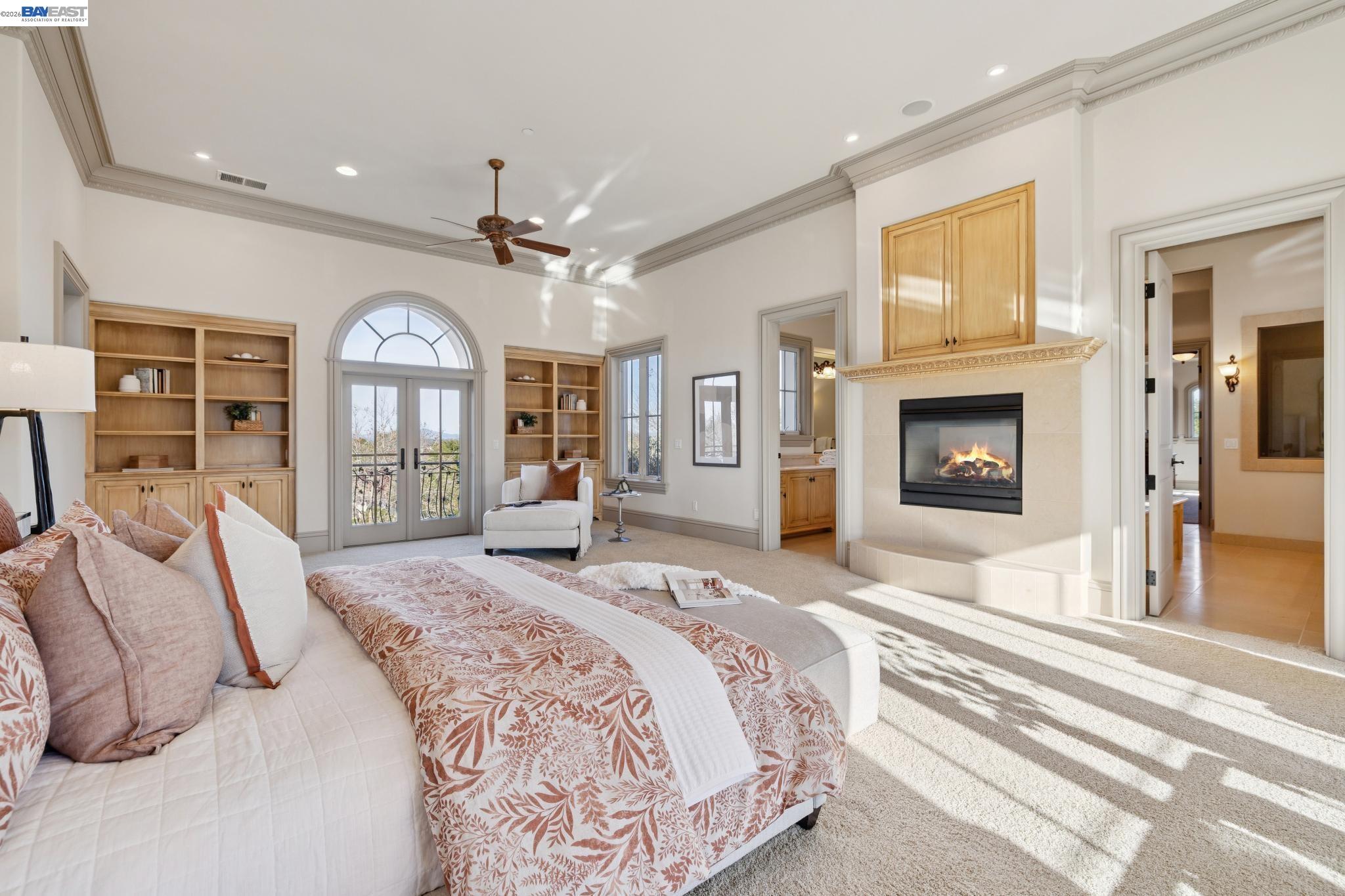 1398 Piemonte Drive Pleasanton, CA 94566 - Photo 39 of 60 a spacious bedroom with a large bed and a fireplace