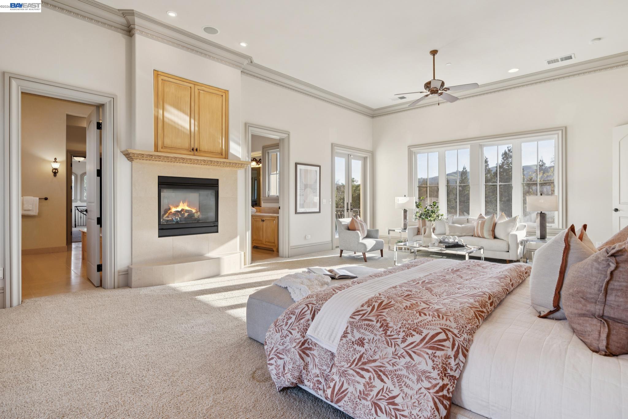1398 Piemonte Drive Pleasanton, CA 94566 - Photo 41 of 60 a spacious bedroom with a large bed and a fireplace