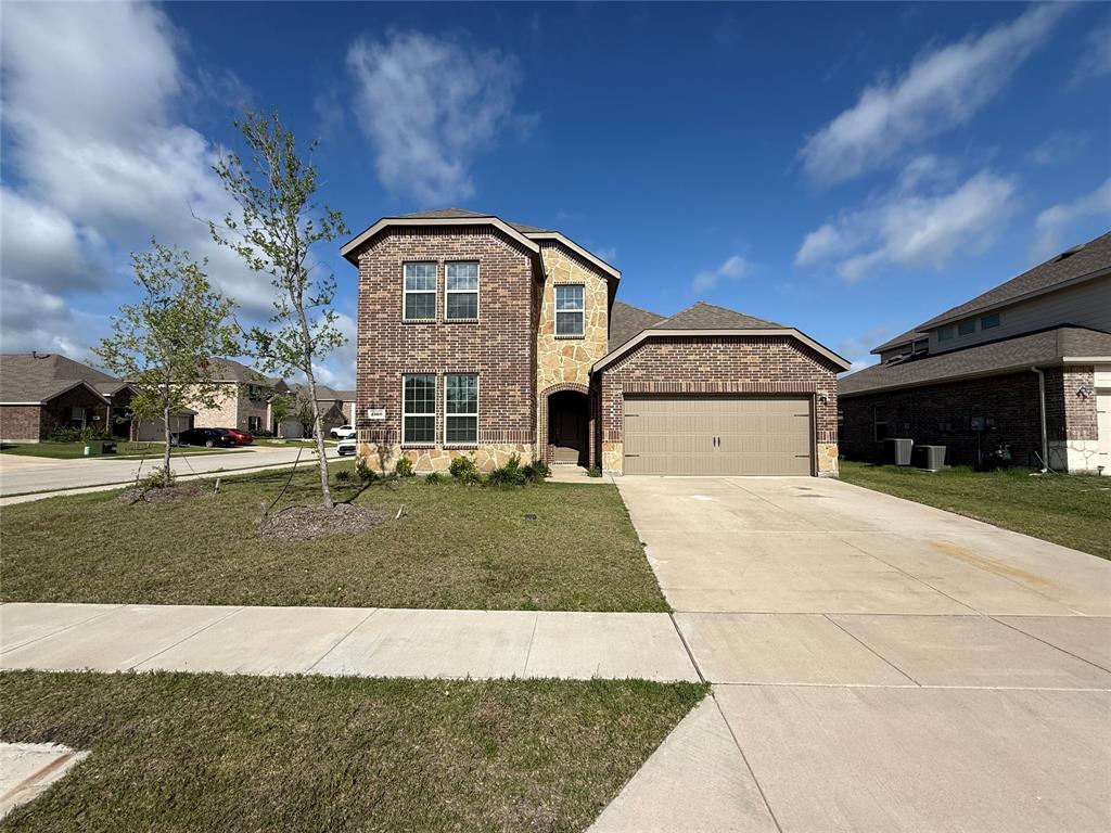 1306 Colonial Bluff Lane Princeton, TX 75407 - Photo 2 of 27 Two-story residence featuring a brick and stone facade, an attached garage, and a concrete driveway