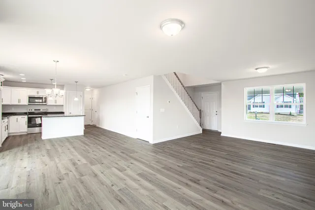 a view of kitchen with cabinets and wooden floor