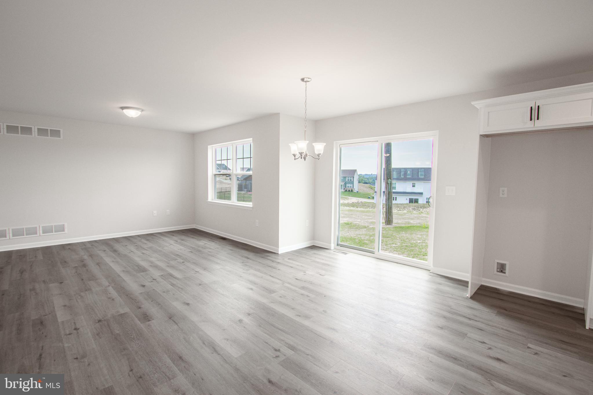 282 Valley View Circle, Unit 141 York, PA 17408 - Photo 12 of 43 an empty room with wooden floor and windows