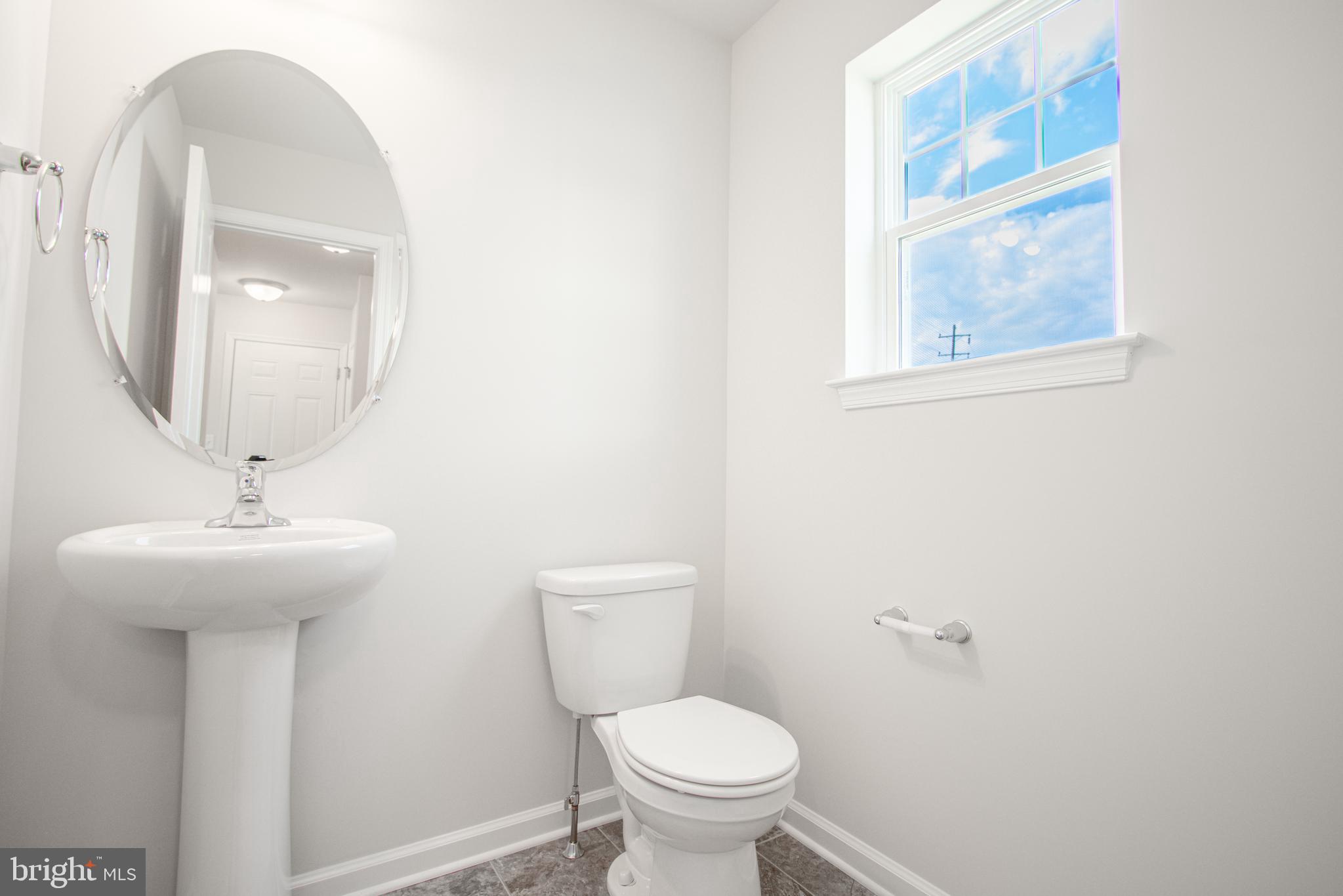 282 Valley View Circle, Unit 141 York, PA 17408 - Photo 21 of 43 a bathroom with a toilet a sink and mirror