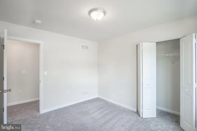 an empty room with closet area