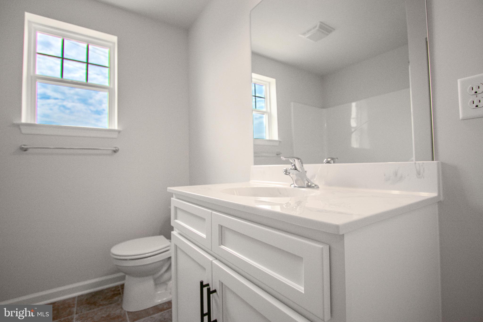 282 Valley View Circle, Unit 141 York, PA 17408 - Photo 32 of 43 a bathroom with a sink toilet vanity and window