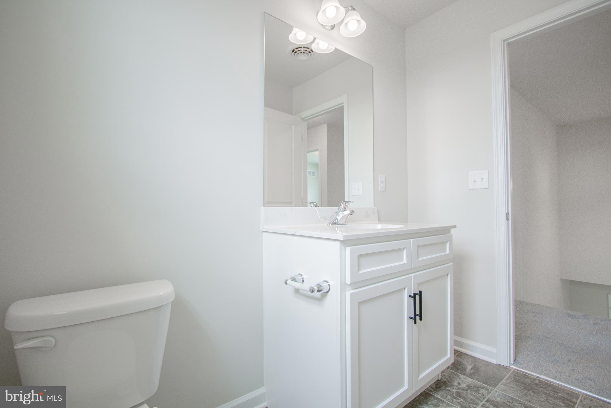 282 Valley View Circle, Unit 141 York, PA 17408 - Photo 33 of 43 a bathroom with a sink vanity and a toilet