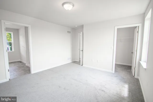 a bathroom with a double vanity sink a toilet and a window