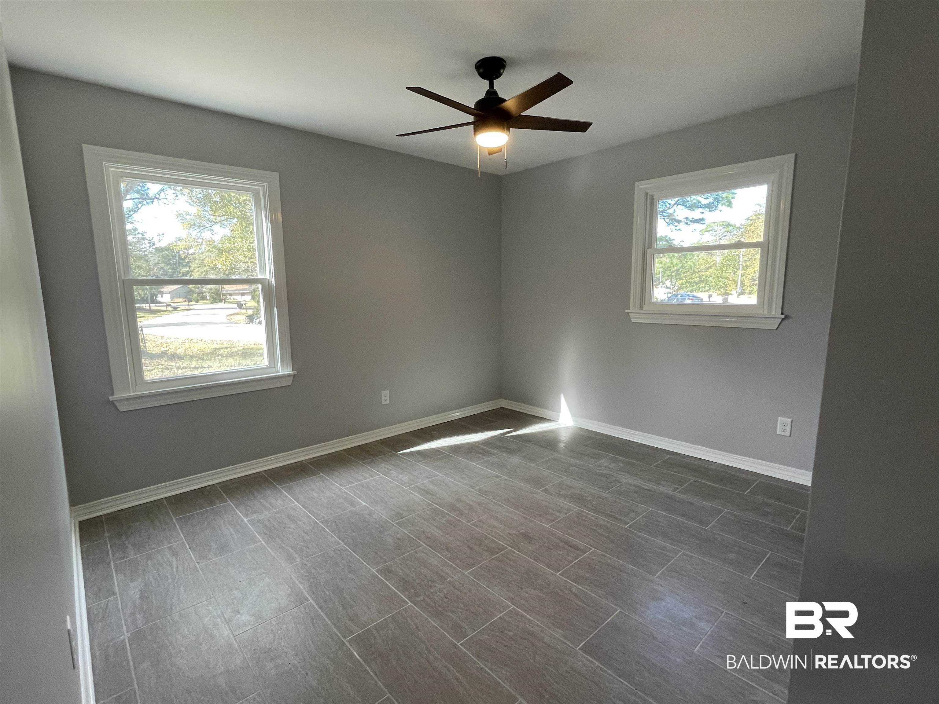 3901 Prima Vera Lane Mobile, AL 36605 - Photo 3 of 15 Unfurnished room featuring ceiling fan and plenty of natural light