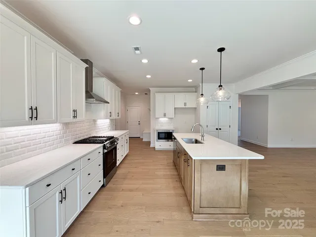 a large white kitchen with lots of counter space