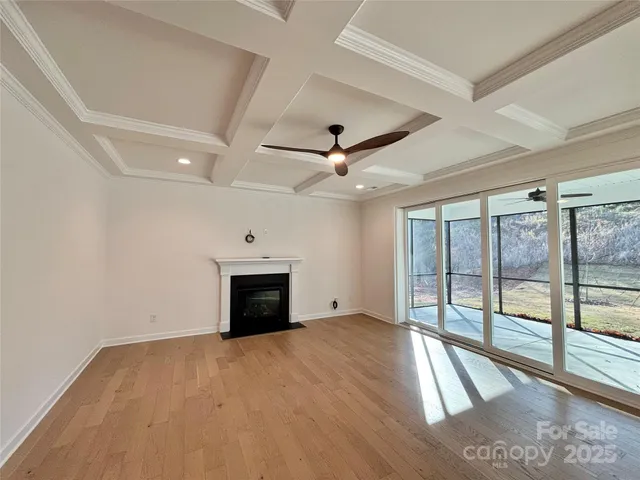 an empty room with fan and windows