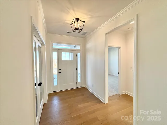 a view of a chandelier fan and entryway