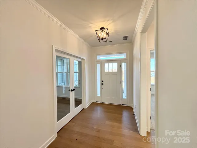 wooden floor in a hall with an entryway