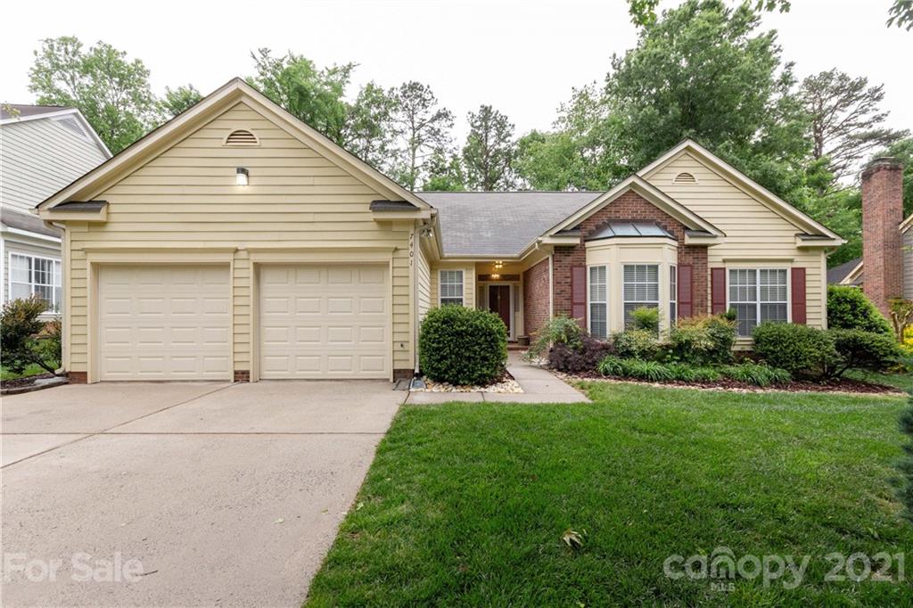 7401 Reedy Creek Road, Unit 24 Charlotte, NC 28215 - Photo 1 of 31 a front view of a house with a yard and garage