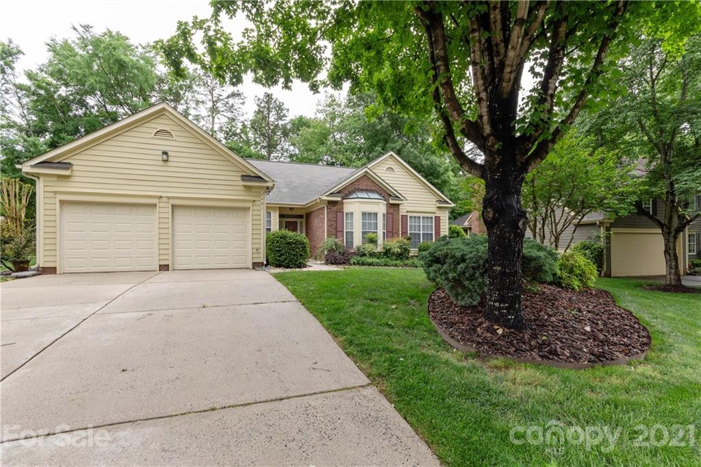 7401 Reedy Creek Road, Unit 24 Charlotte, NC 28215 - Photo 2 of 31 a front view of a house with a garden
