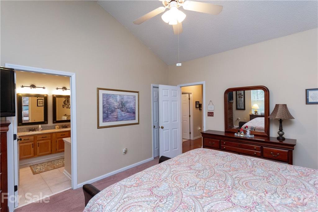 7401 Reedy Creek Road, Unit 24 Charlotte, NC 28215 - Photo 16 of 31 a bedroom with a bed and a mirror on the dresser