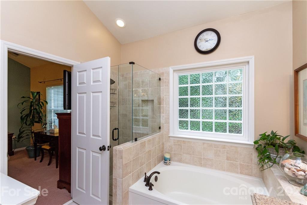 7401 Reedy Creek Road, Unit 24 Charlotte, NC 28215 - Photo 17 of 31 a bathroom with a tub and a window